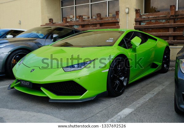 Terengganu, Malaysia - March 2019:\
Lime green Lamborghini parked in the afternoon in\
Malaysia.