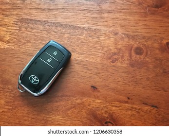 TERENGGANU, MALAYSIA - Oct 18, 2018 : Keyless remote for car or vehicle with Toyota logo on it isolated on wooden background with copy space for text.