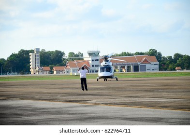 Terengganu,Malaysia-16 April 2017: Ground Crew Members Of Air Traffic Controllers Gives A Signal To A Helicopter Arrived At The Sultan Mahmud Airport, Terengganu.