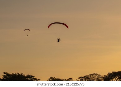 TEREZOPOLIS, BRAZIL - APRIL 22, 2022: Man flaying at brazilian sky in a paramotor on Terezopolis, 2022, Brazil.