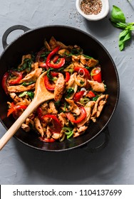 Teriyaki Chicken, Bell Peppers, Onions And Spinach Stir Fry In A Pan On A Gray Background, Top View