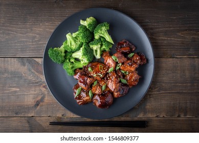 Teriyaki Chicken And Broccoli On Black Plate