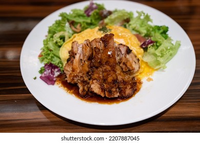 Teriyaki Chiken Omelette Rice In White Plate Isolated With Wooden Background