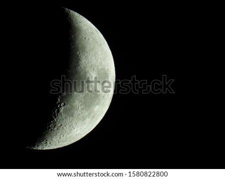 Similar – Image, Stock Photo Increasing crescent moon in dark blue evening sky with light clouds, moon craters and moon seas are visible