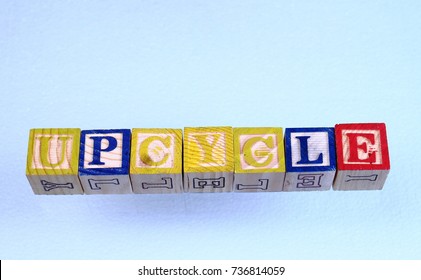 The Term Upcycle Visually Displayed On A Clear Background Using Colorful Wooden Toy Blocks In Landscape Format With Copy Space