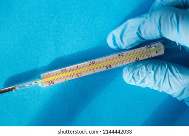 Termometer In A Hand Of A Doctor In Glove