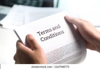 Terms And Conditions Text In Legal Agreement Or Document About Service, Insurance Or Loan Policy. Lawyer Or Client Holding Contract Paper In Office.