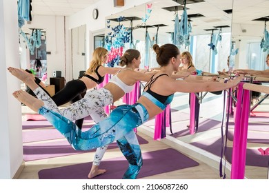 Ternopil, Ukraine - January 26, 2020: Women Group In Fitness Class Doing Stretching Exercises Near Barre In Studio. Team. Health Lifestyle