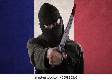 Terorrism Concept: Terrorist Threatening With A Knife In Front Of France National Flag