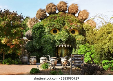 TERRA BOTANICA, ANGERS, FRANCE - SEPTEMBER 24, 2023: Head of a monster covered with ivy in a park landscape design. Grass figure