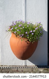 Terra Cotta Flower Pot Mounted To A Wall