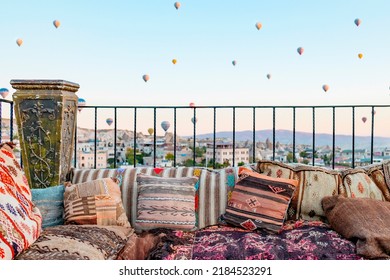 Terrace Of Hotel In Goreme Cappadocia And Hot Air Balloons Rising Into Sky, Concept  Of Must See Travel Destination, Bucket List Trip