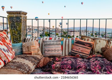 Terrace Of Hotel In Goreme Cappadocia And Hot Air Balloons Rising Into Sky, Concept  Of Must See Travel Destination, Bucket List Trip