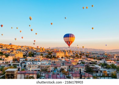 Terrace Of Hotel In Goreme Cappadocia And Hot Air Balloons Rising Into Sky, Concept  Of Must See Travel Destination, Bucket List Trip