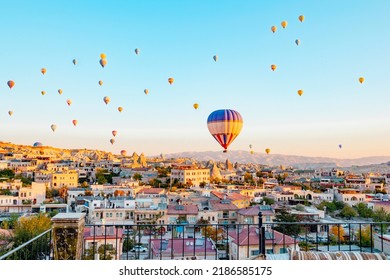 Terrace Of Hotel In Goreme Cappadocia And Hot Air Balloons Rising Into Sky, Concept  Of Must See Travel Destination, Bucket List Trip