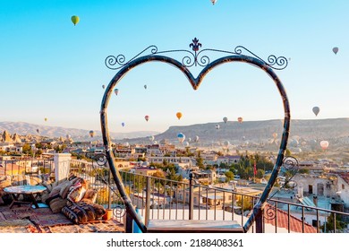 Terrace Of Hotel In Goreme Cappadocia And Hot Air Balloons Rising Into Sky, Concept  Of Must See Travel Destination, Bucket List Trip