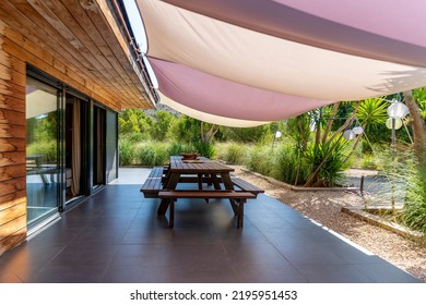 Terrace Table On The Porch Of A Country House With An Awning Covering It From The Sun.