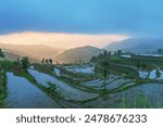 The terraced fields filled with water and the beautiful sunset in the mountainous areas of Zhejiang Province, China