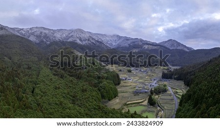 Terraced rice fields and snowy mountains in traditional Japanese village