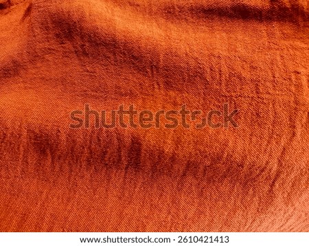 Terracotta Background with Textured Surface. exploring terracotta color fabric before making it into a beautiful dress. Red brown burnt orange terracotta coral abstract background. Empty space. Design