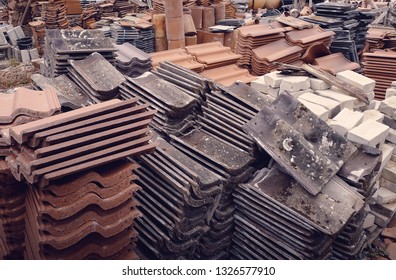 Terracotta And Composite Reclaimed Roof Tiles At A Salvage Yard In The UK.