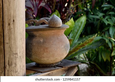 Terracotta Drinking Water Pot For Passerby Placed In Front Of A Traditional Rural House In Northern Thailand. The Clay Pot Keeps Water Cooler Than Ambient Temperature.