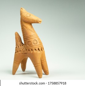 Terracotta miniature horse on white background 