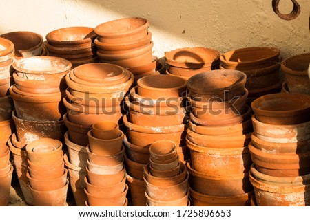 Terracotta pots; piles and stacks of empty orange vintage flowerpots. Filling the frame