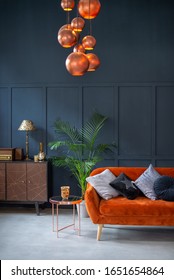 Terracotta Sofa In Front Of A Dark Blue Wall. Stylish Living Room Interior