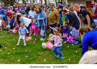 Terre Hill, PA, USA - April 16, 2022: Children Scramble For Easter Eggs During A Hunt That Are Scattered At A Local Spring Community Event In A Rural Lancaster County, Pennsylvania Park.