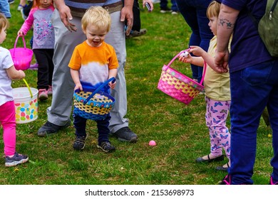 Terre Hill, PA, USA - April 16, 2022: Children Scramble For Easter Eggs During A Hunt That Are Scattered At A Local Spring Community Event In A Rural Lancaster County, Pennsylvania Park.