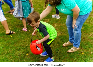 Terre Hill, PA, USA - April 16, 2022: Children Scramble For Easter Eggs During A Hunt That Are Scattered At A Local Spring Community Event In A Rural Lancaster County, Pennsylvania Park.