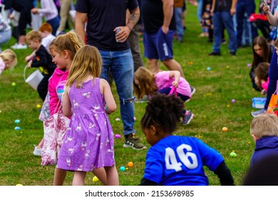 Terre Hill, PA, USA - April 16, 2022: Children Scramble For Easter Eggs During A Hunt That Are Scattered At A Local Spring Community Event In A Rural Lancaster County, Pennsylvania Park.