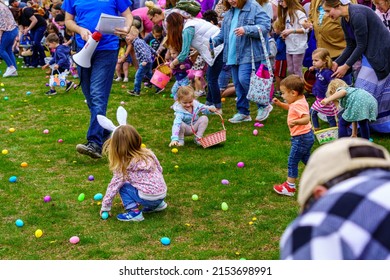 Terre Hill, PA, USA - April 16, 2022: Children Scramble For Easter Eggs During A Hunt That Are Scattered At A Local Spring Community Event In A Rural Lancaster County, Pennsylvania Park.