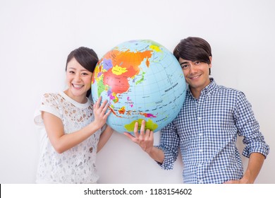 A Terrestrial Globe And Man And Woman