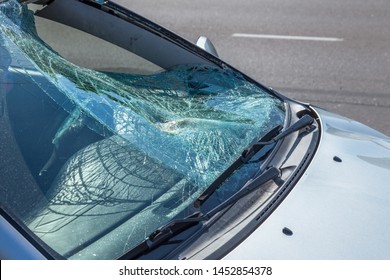 Terrible dangerous car after a fatal accident. Broken windshield. A broken car with broken glass. Сar hazard. Reckless dangerous driving. Broken windshield after fatal accident with a pedestrian