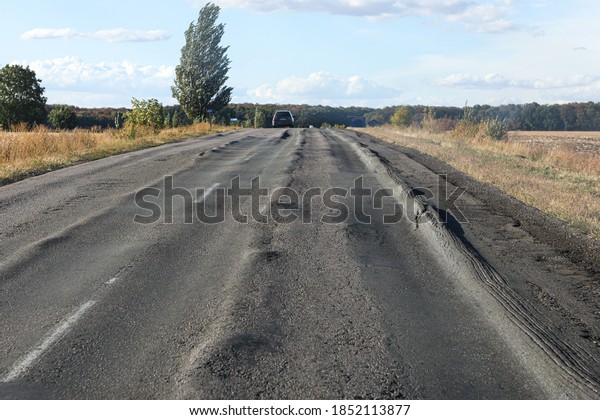 terrible road with longitudinal rut. Poor\
asphalt surface.
