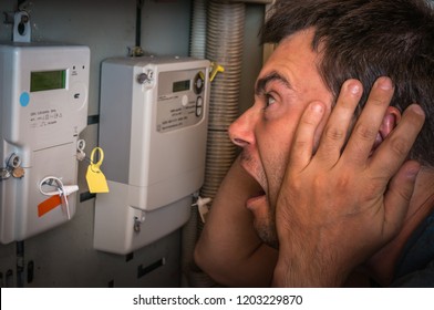 Terrified Man Is Checking Electricity Meter - Consumption And Expensive Electricity Concept