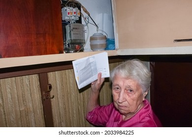 Terrified Senior Poor Woman Is Checking Electricity Meter - Consumption And Expensive Electricity Concept