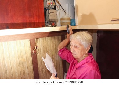 Terrified Senior Poor Woman Is Checking Electricity Meter - Consumption And Expensive Electricity Concept