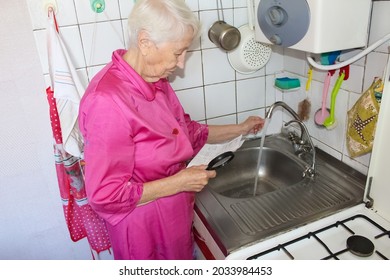 Terrified Senior Poor Woman Is Checking Water Meter At Home- Consumption And Expensive Water Concept