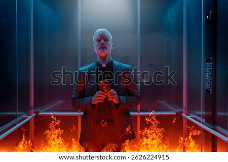 Terrified sinful priest standing in an elevator surrounded by flames and going to hell, he is holding a Bible and looking up