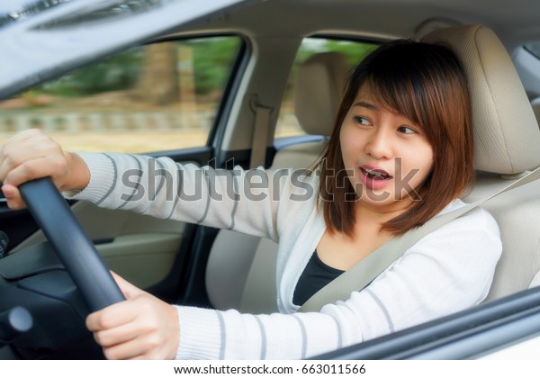 Terrified woman driving and having car accident\
or crash something
