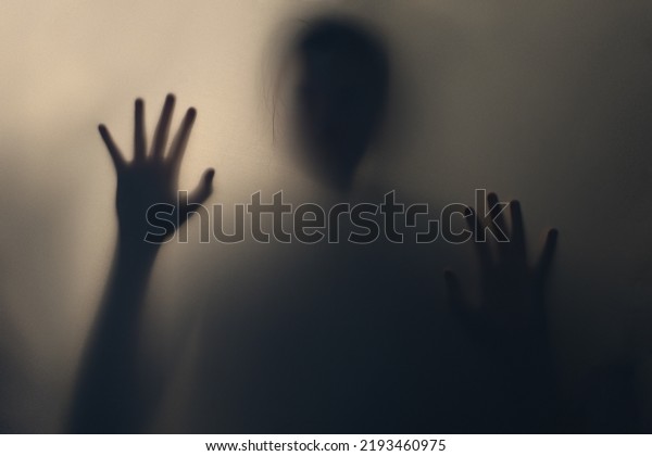 Terrifying blurry ghostly shadow of a man with\
flowing hair. Silhouette of a ghost, monster, alien, creature. The\
concept of fear, horror, scary, hallucination, psycho nightmare,\
halloween festival.