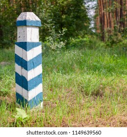 Territorial Sign. Wooden Green And White  Striped Post In The Forest. Forest Area Designation. For Instagram Format. Square. Outdoors. Close-up.