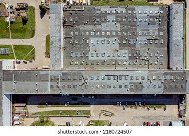 Territory Of An Industrial Plant. Factory Roof With Skylights And Ventilation System. View From Above.