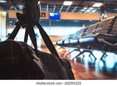 Terrorism In Aiport. Dangerous Terrorist Planning A Bomb Attack In The Waiting Area And Gate. Holding Suspicious Black Bag With Leather Gloves. Anonymous Criminal. Safety And Security Threat Concept.