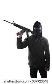 Terrorism concept: Terrorist holding a machine gun in his hands isolated over white