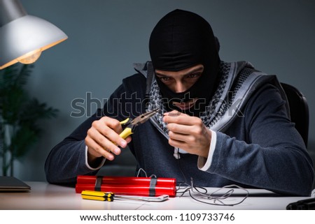 Terrorist bomber preparing dynamite bomb