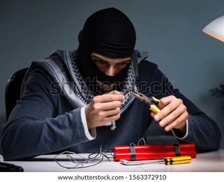Terrorist bomber preparing dynamite bomb